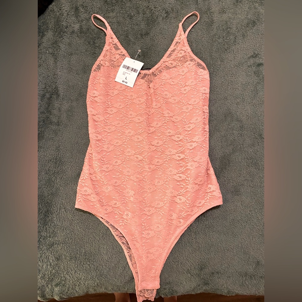 Pink floral bodysuit with lace see through backing. Never worn, new with tags!